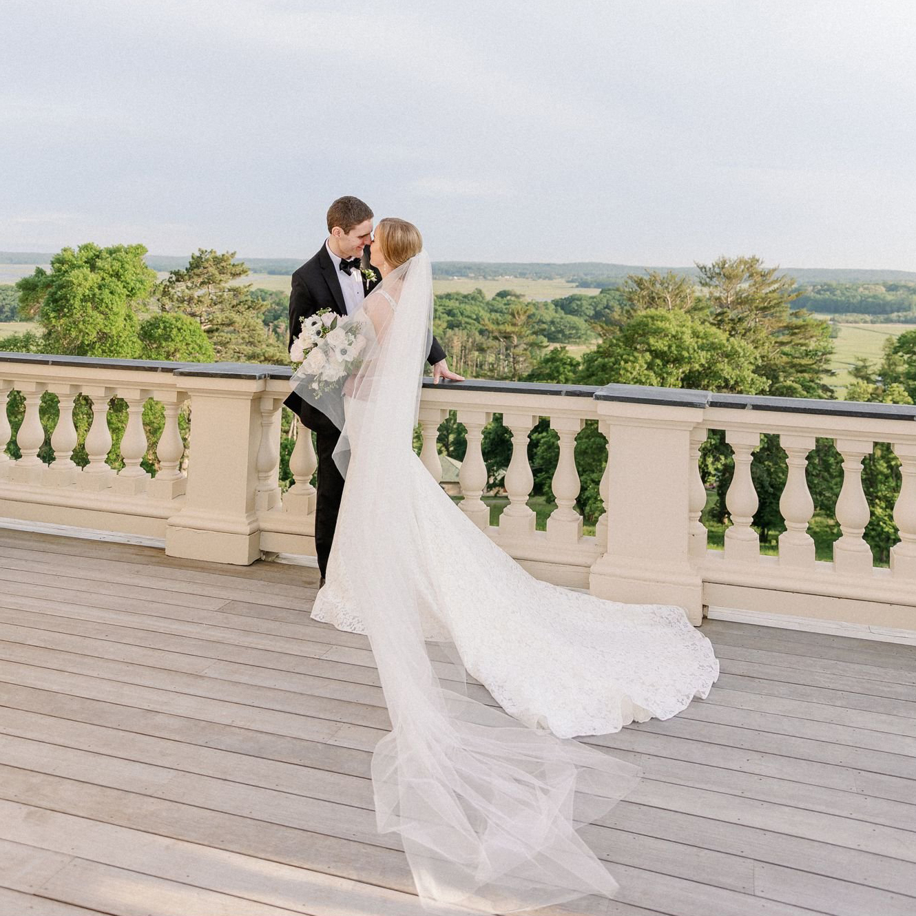 Couple kiss during sunset on the rooftop of the Crane Estate