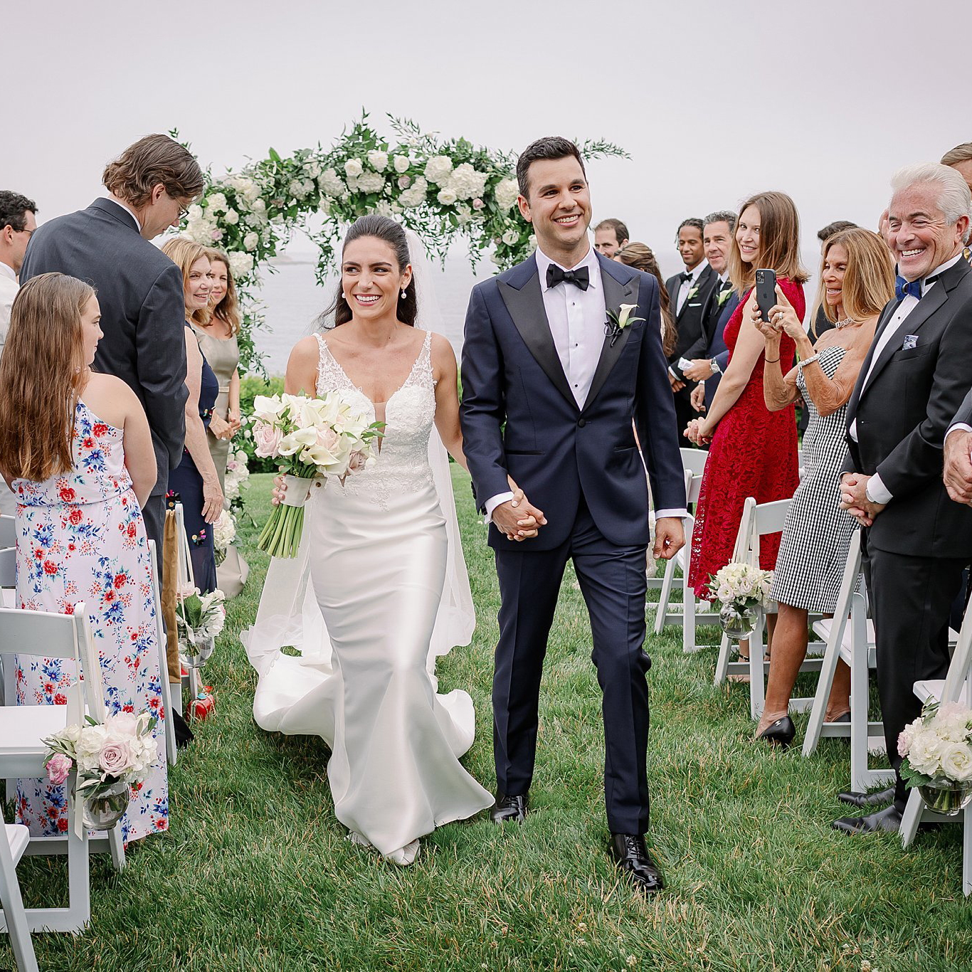 Couple walk down the aisle smiling after getting married at The Chanler Newport. Deborah Zoe Photography