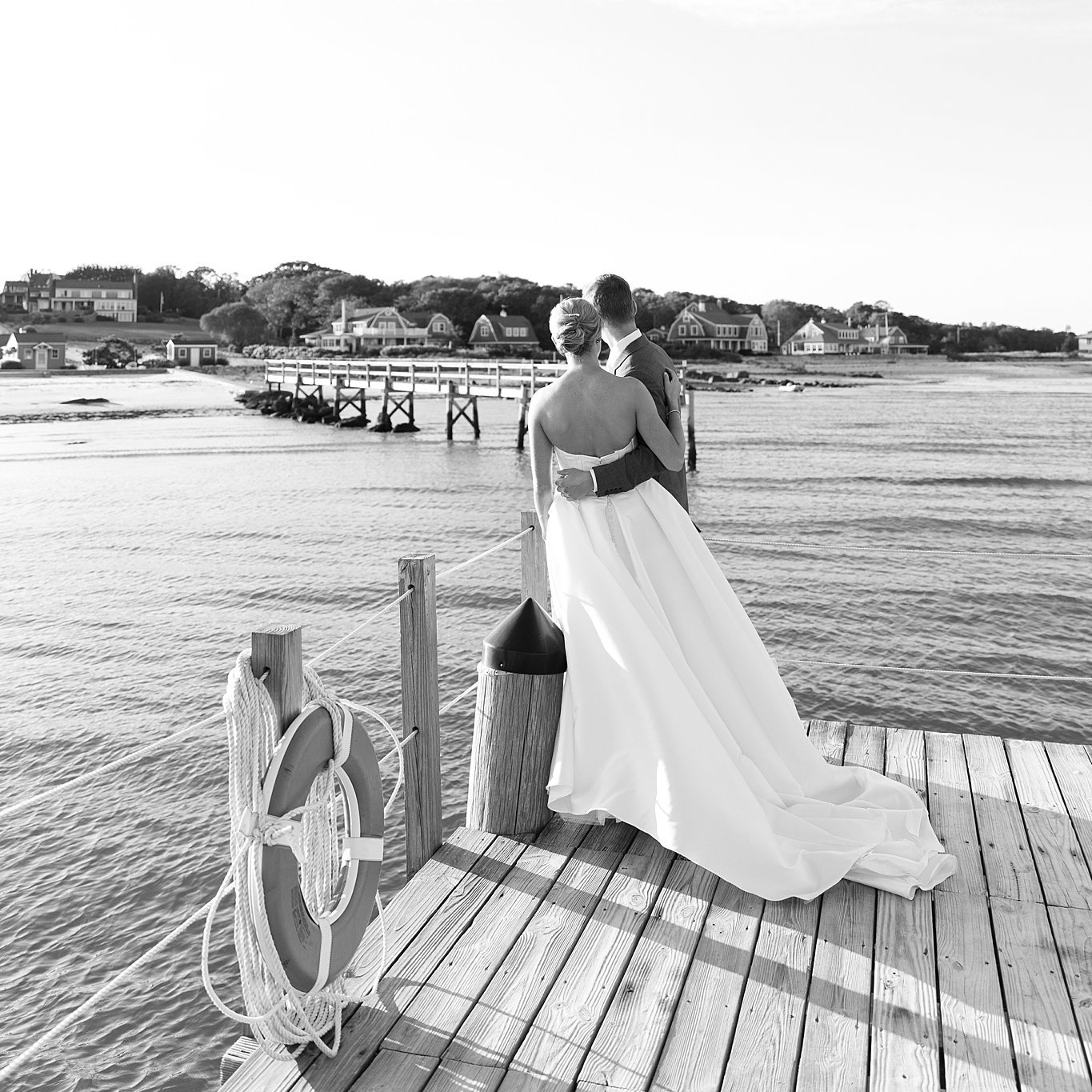 Couple out over harbor while standing on a dock. South Dartmouth Wedding Deborah Zoe Photography.