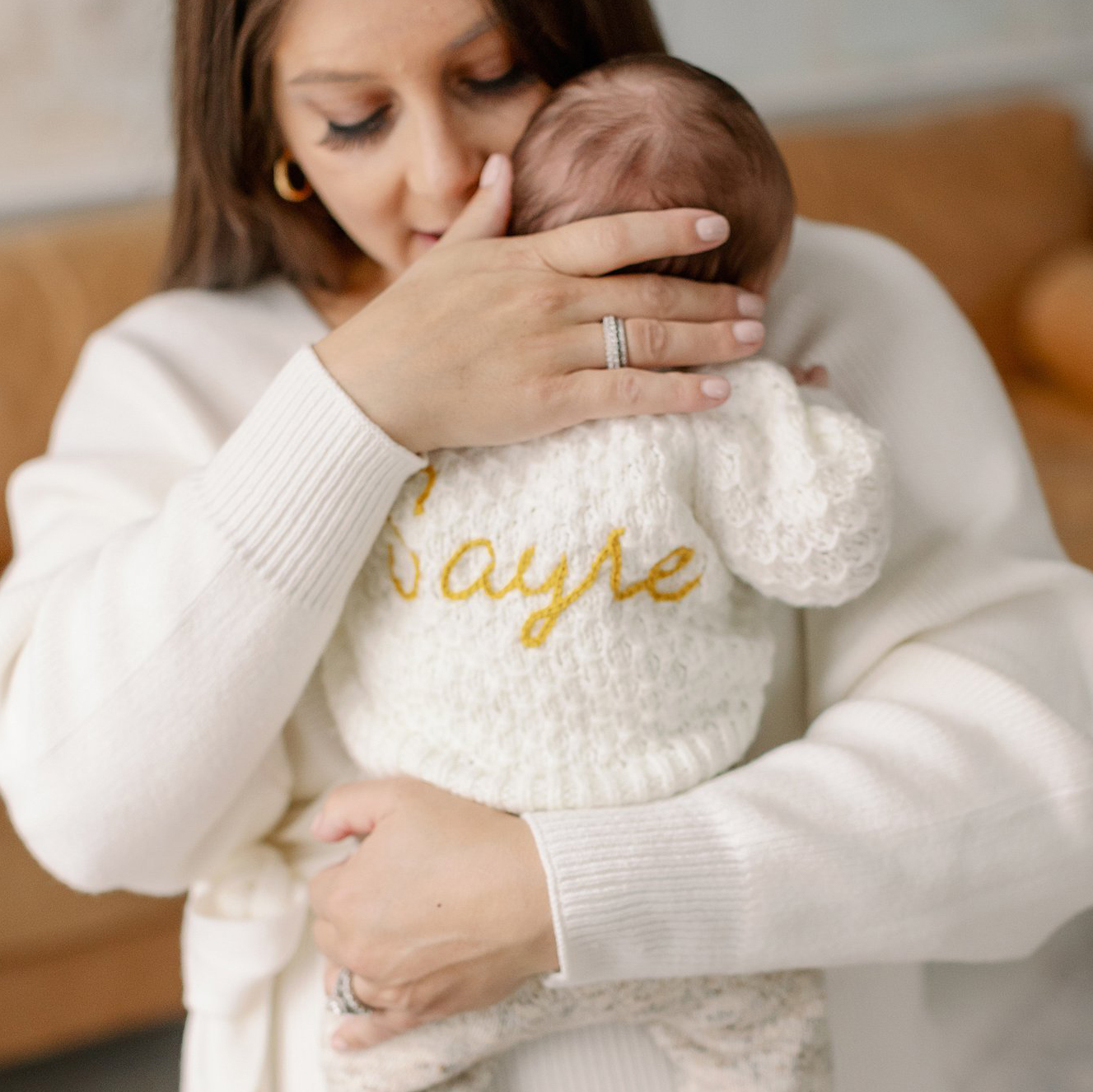 Mother holds her newborn in her arms. Deborah Zoe Photography Boston Newborn Session.