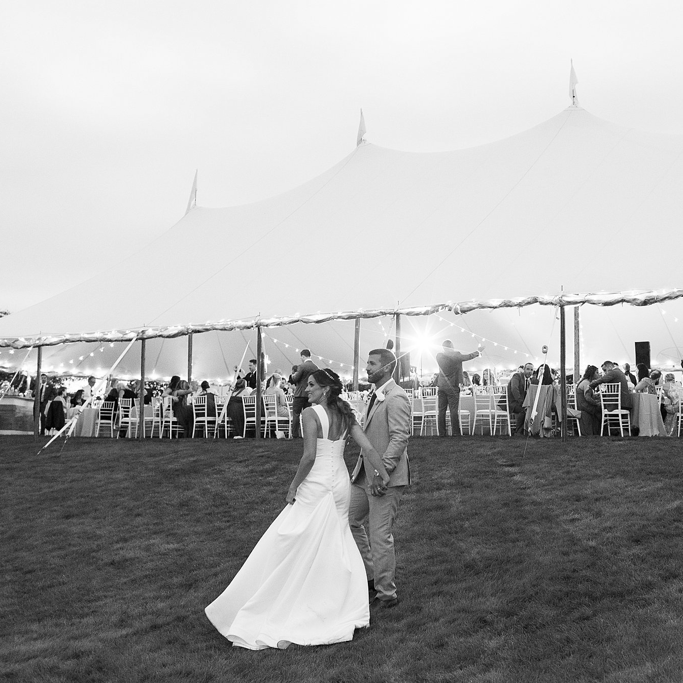 Couple stand in front of tent during reception at Viewpoint Hotel in Maine. Deborah Zoe Photography.