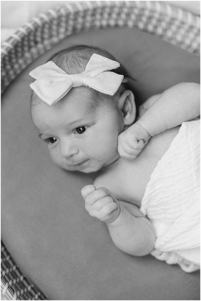 Close up of swaddled newborn wearing a bow. Boston Newborn Session Deborah Zoe Photography