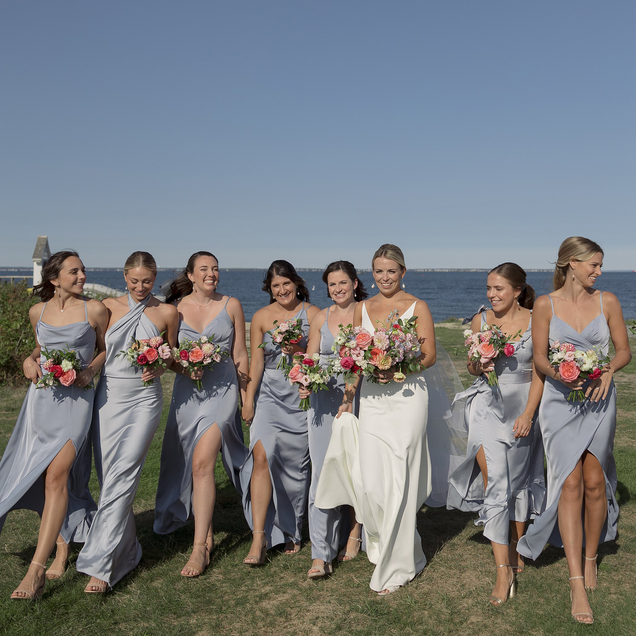 Bridesmaids smile as they walk with Bride dressed in baby blue silk dress. South Dartmouth Wedding Deborah Zoe Photography