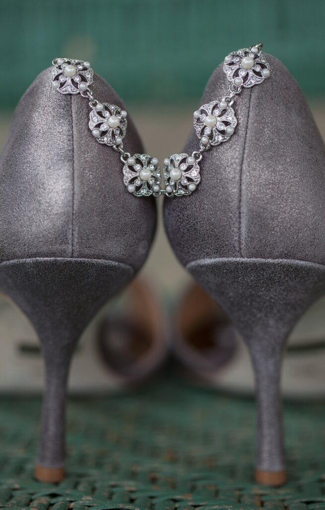 Detail of grey heels with a bracelet draped over them. Vermont Wedding Photographer Deborah Zoe Photography