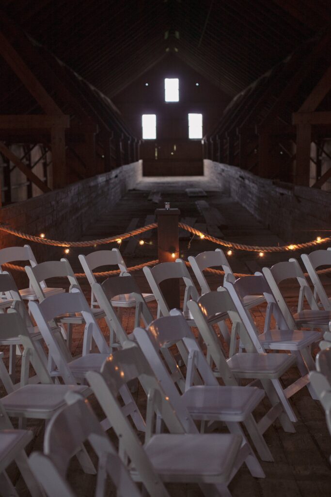 Chairs in barn for wedding ceremony. Vermont Wedding Photographer Deborah Zoe Photography