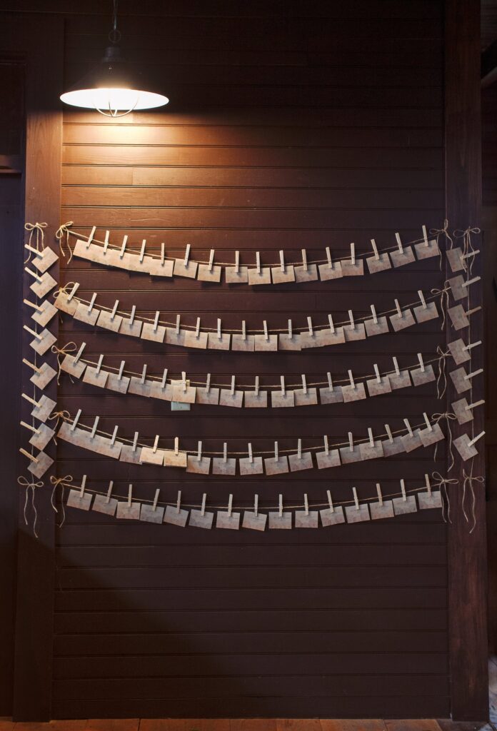 Table place cards hung on the wall. Vermont Wedding Photographer Deborah Zoe Photography