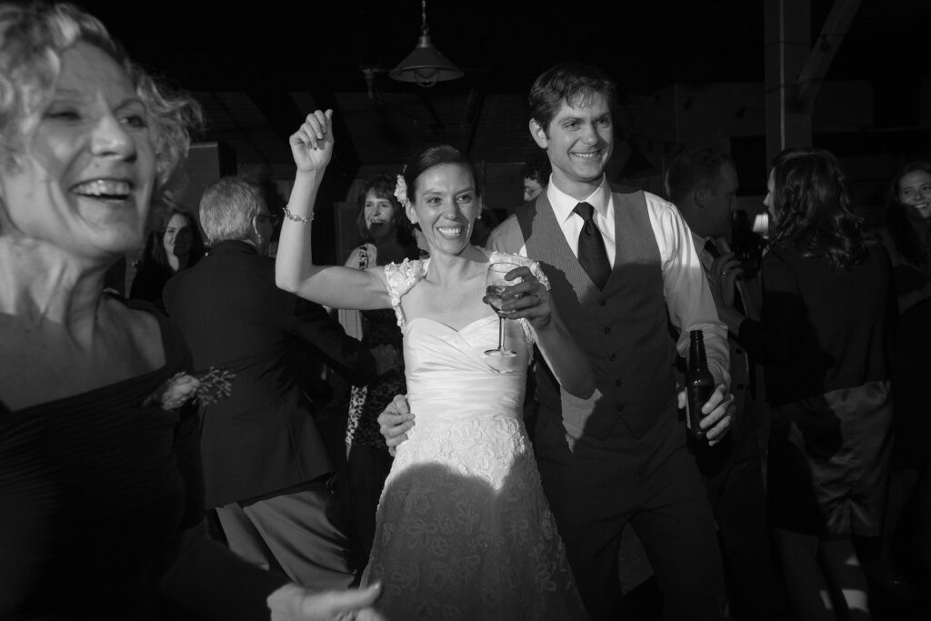 Bride and Groom dance and smile during wedding reception. Vermont Wedding Photographer Deborah Zoe Photography