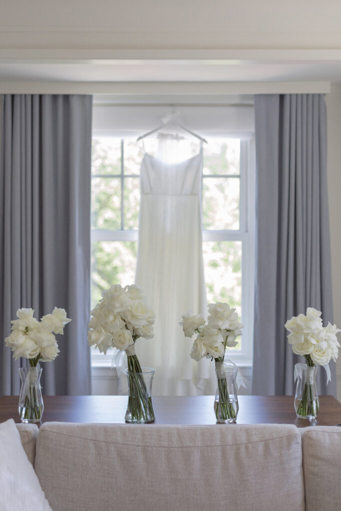 Wedding dress hangs in the window at the Newbury Boston. Modern Summer Wedding at the Newbury Boston Hotel photographed by Deborah Zoe Photography. 