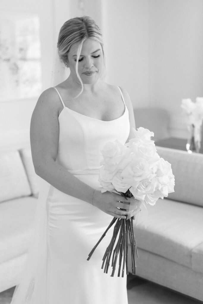 Bride looks down at her bouquet. Modern Summer Wedding at the Newbury Boston Hotel photographed by Deborah Zoe Photography. 