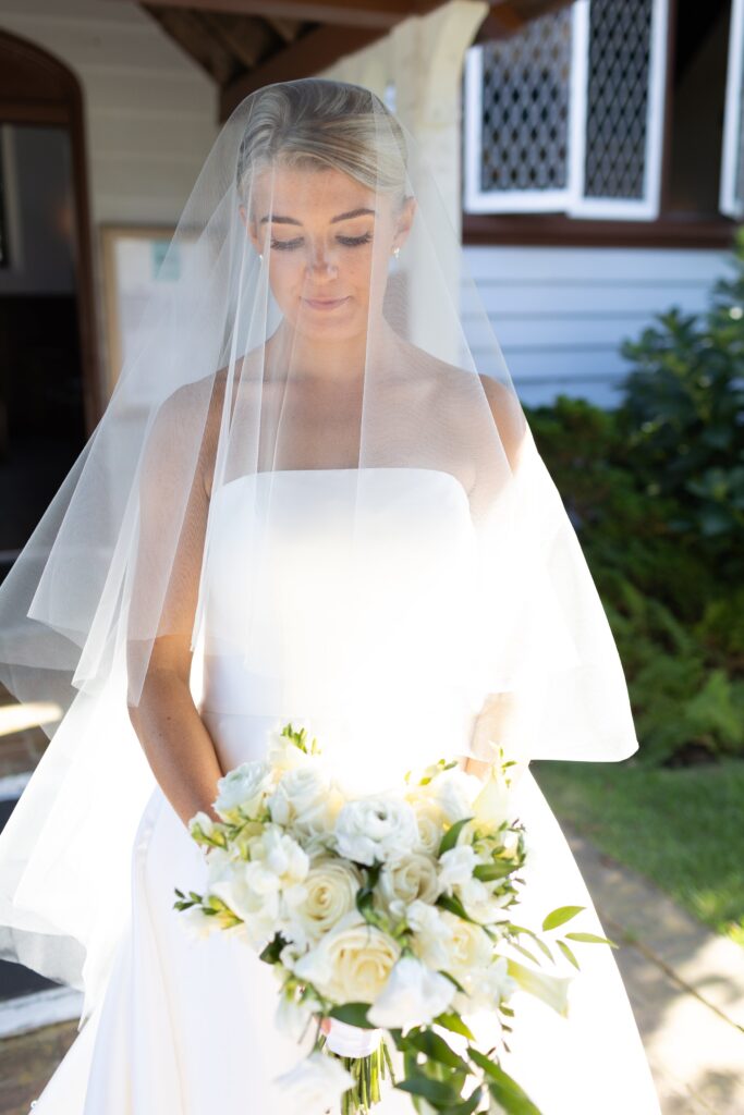 Bride wear veil over her face for a bridal portrait. Coastal New England Wedding.