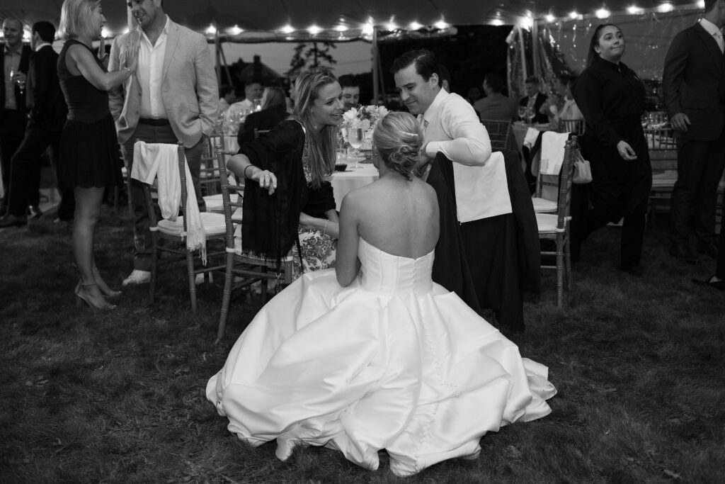 Bride speaks to wedding guests during tented wedding reception. Coastal New England Wedding.