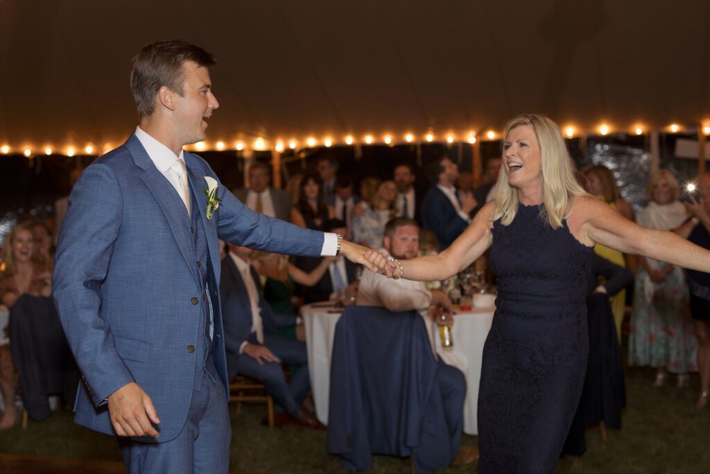 Groom dances with his mom on the dancefloor during wedding reception. Coastal New England Wedding.