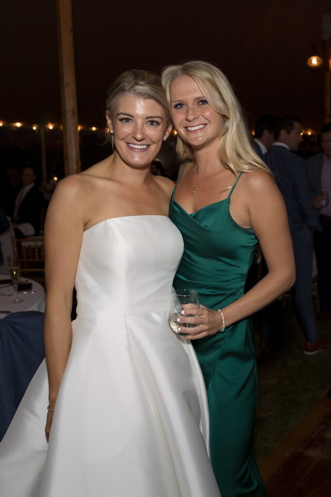 Guests celebrate and dance on the dancefloor during tented wedding reception. Coastal New England Wedding.